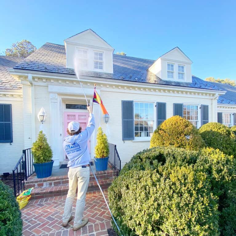 Residential home being professionally serviced by alpha exterior solutions soft washing services