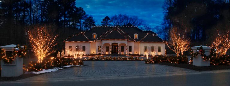 large residential estate with holiday lighting on roofline and landscaping installed by alpha exterior solutions and holiday lighting