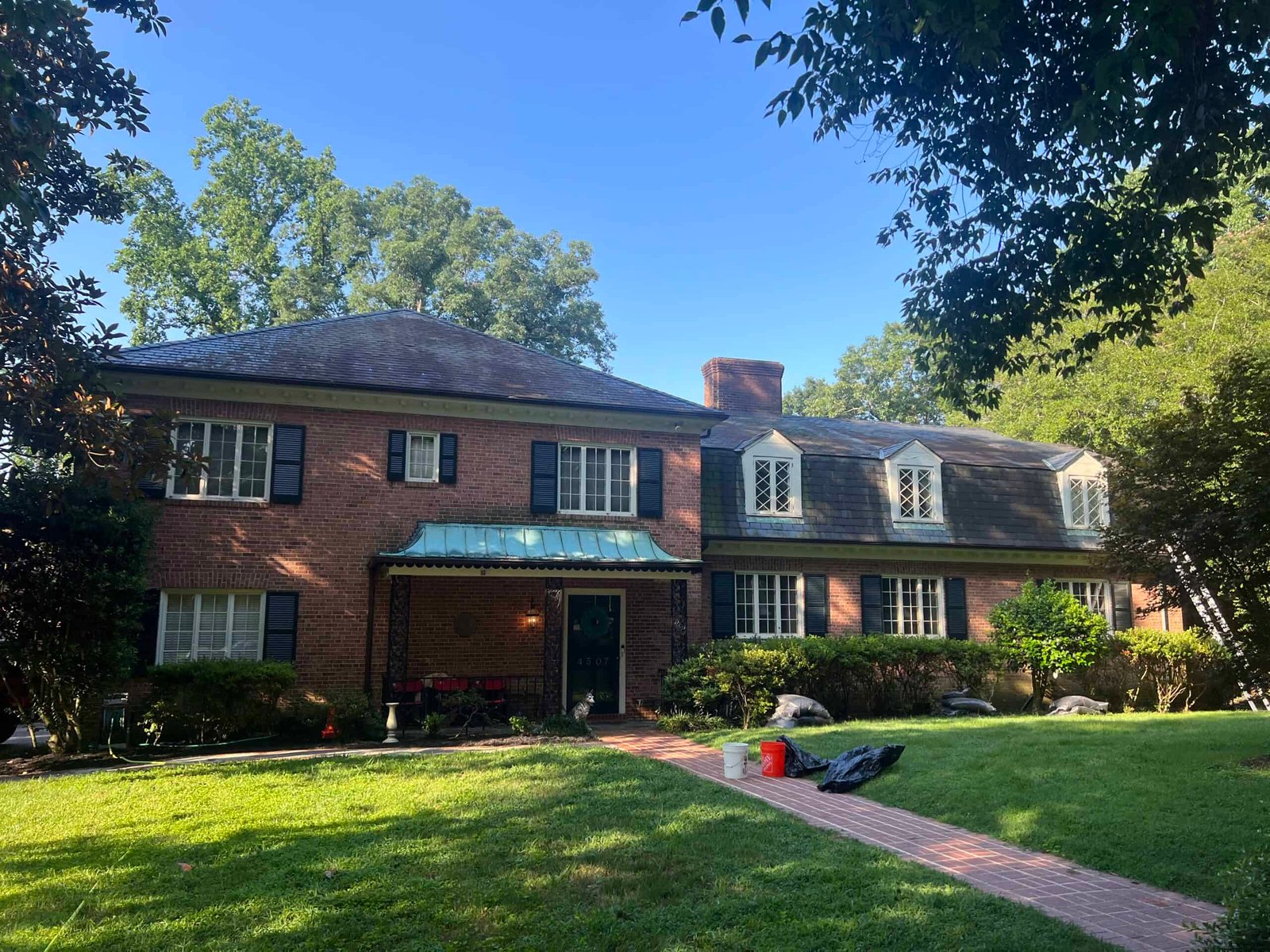 residential home with cedar roof before roof cleaning and soft washing by alpha exterior solutions