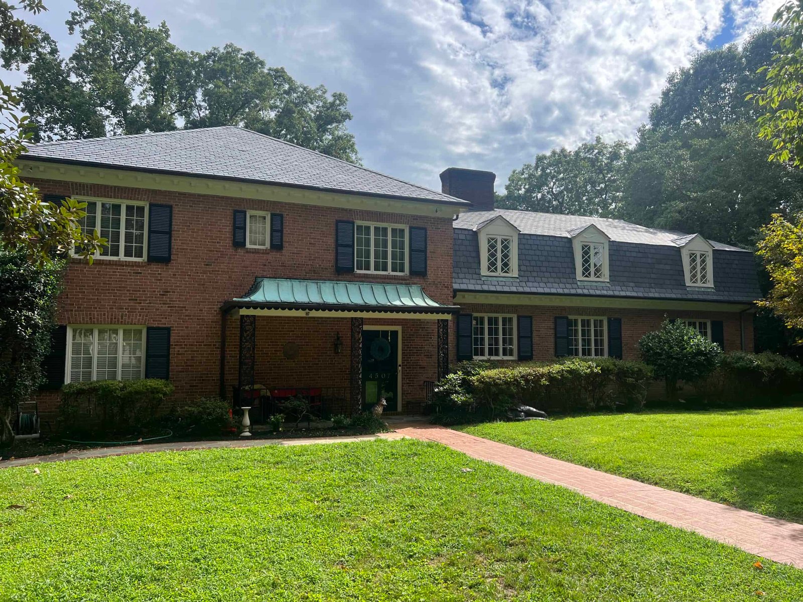 residential home with cedar roof after roof cleaning and soft washing by alpha exterior solutions