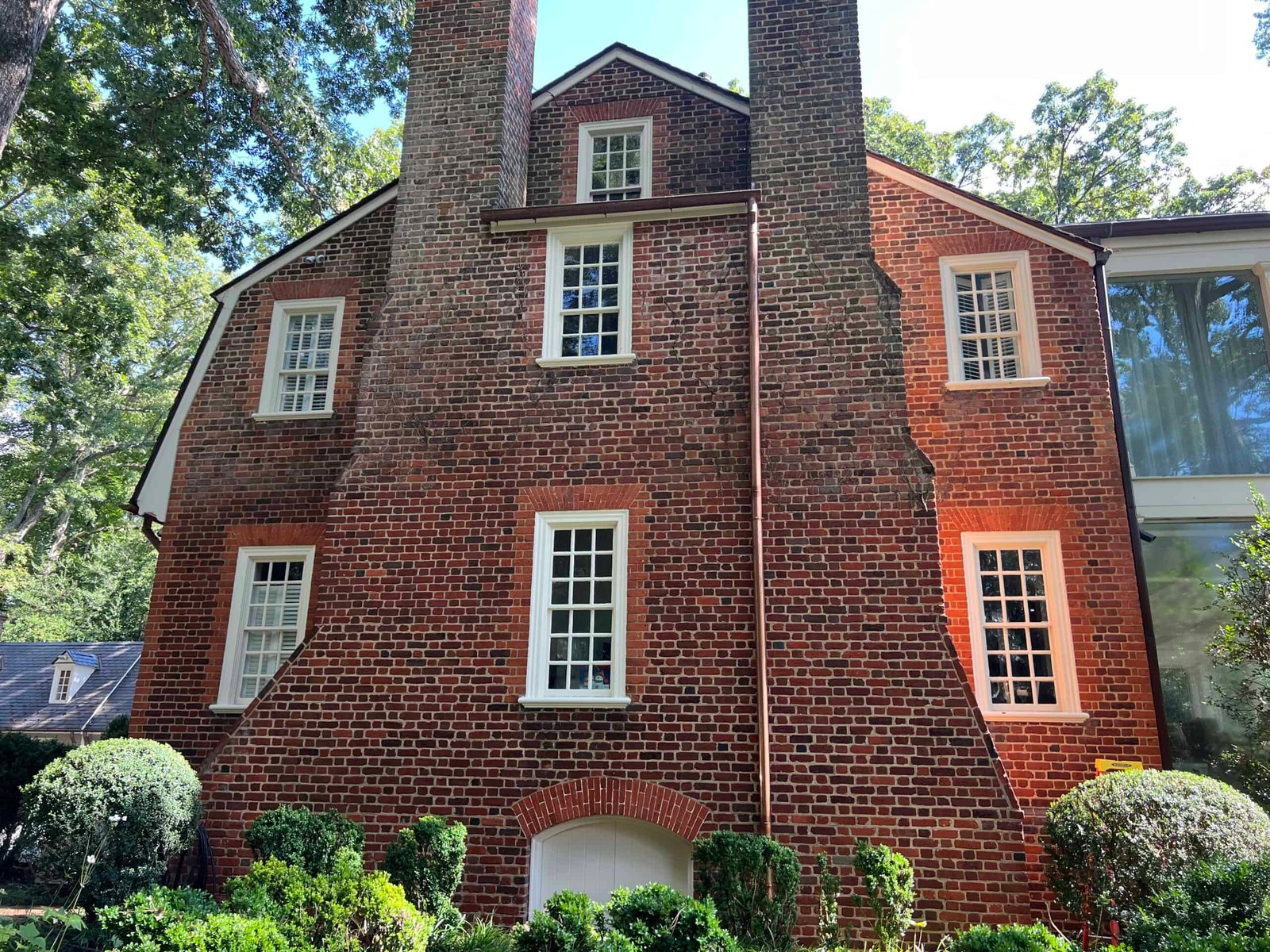 Large residential home covered in dirt and grime before professional soft washing by alpha exterior solutions