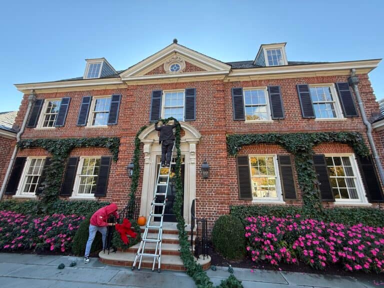 2 story residential home with garland and wreath installation for christmas holiday season by alpha exterior solutions and holiday lighting