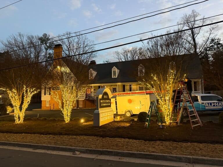 Commercial building being decorated with christmas light display by alpha holiday lighting