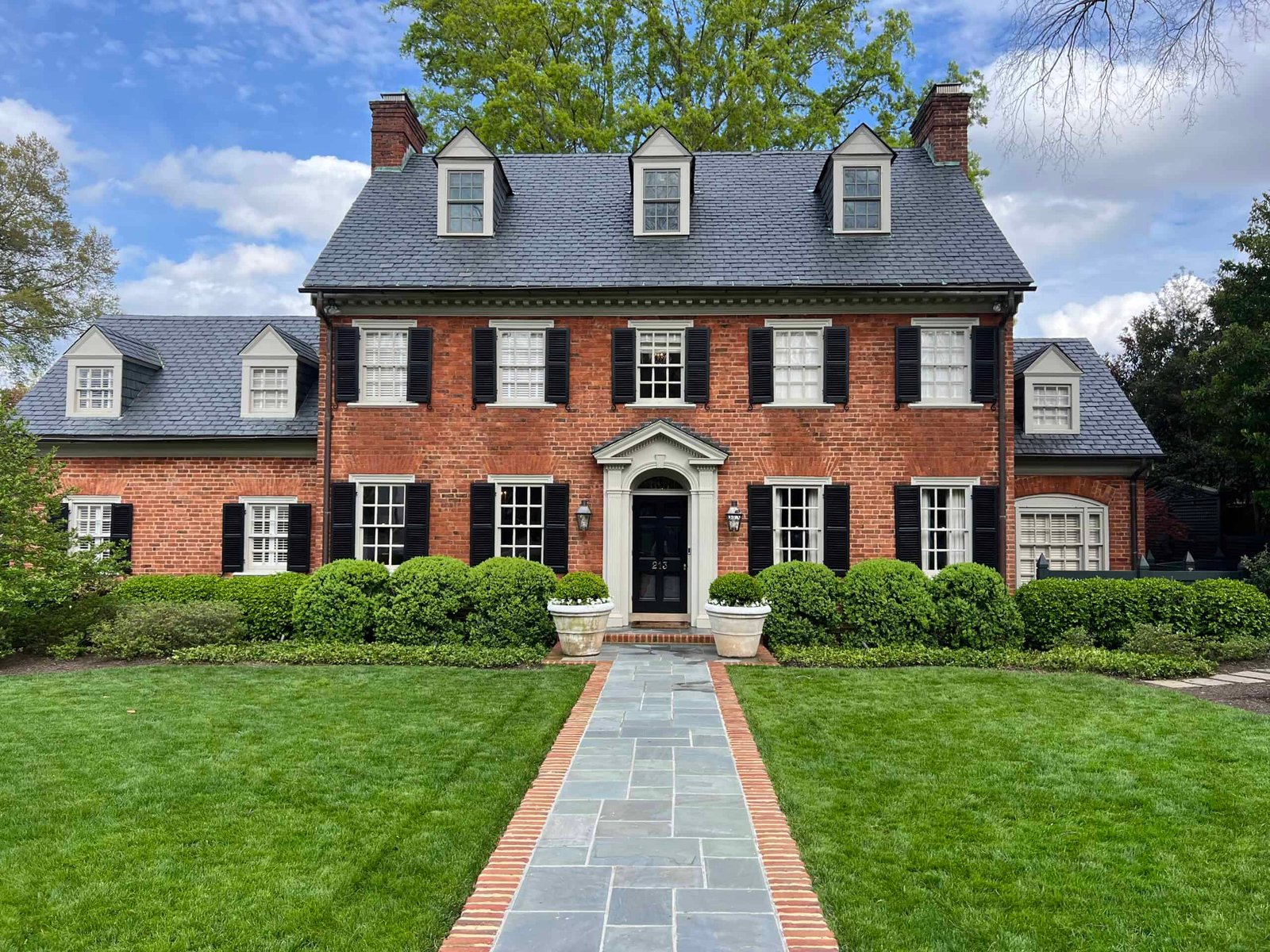 beautiful brick home with cedar roof after roof soft washing and exterior cleaning by alpha exterior services