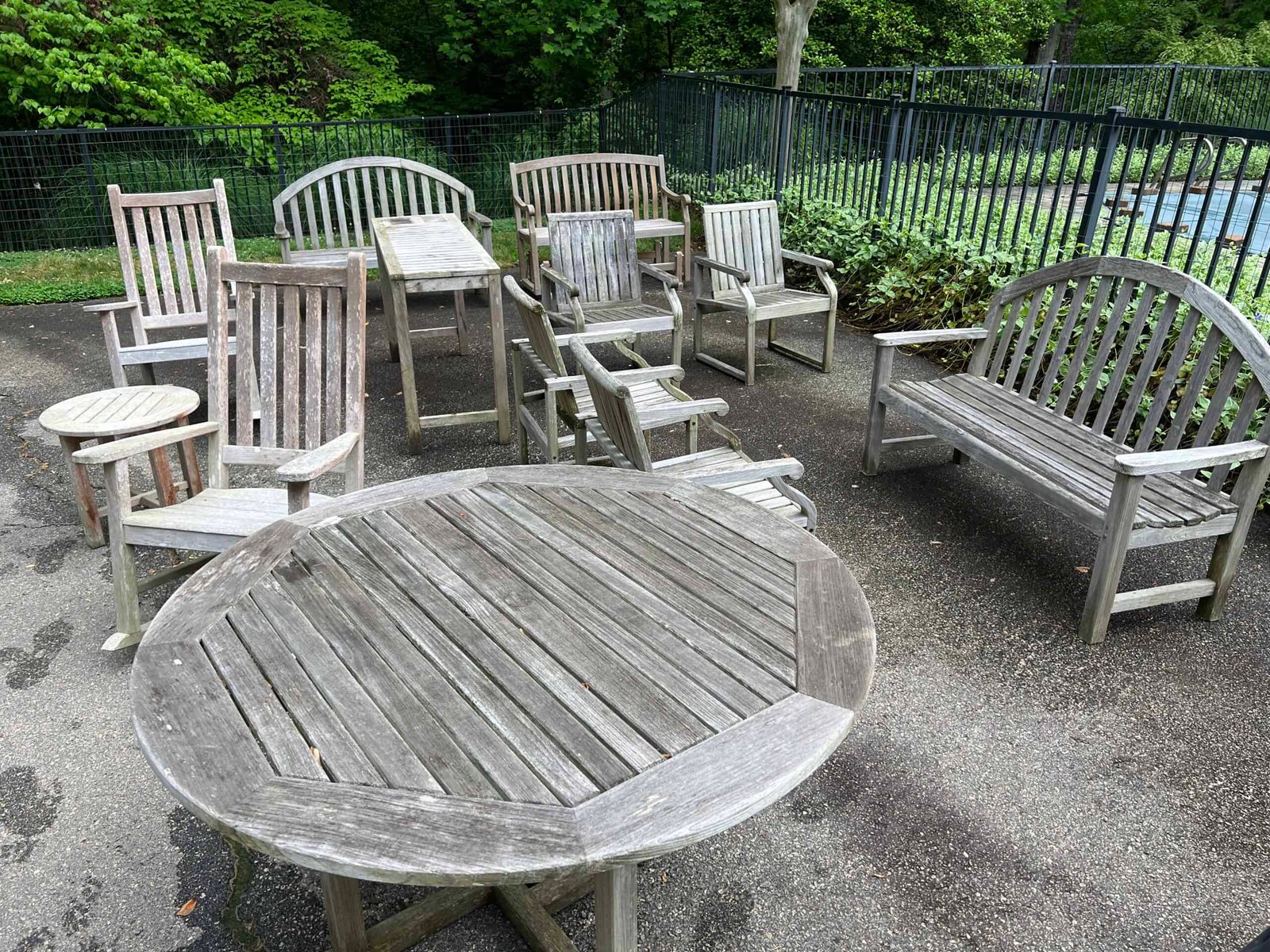 weathered, grey wooden patio furniture before revive by soft washing and staining preformed by alpha exterior solutions