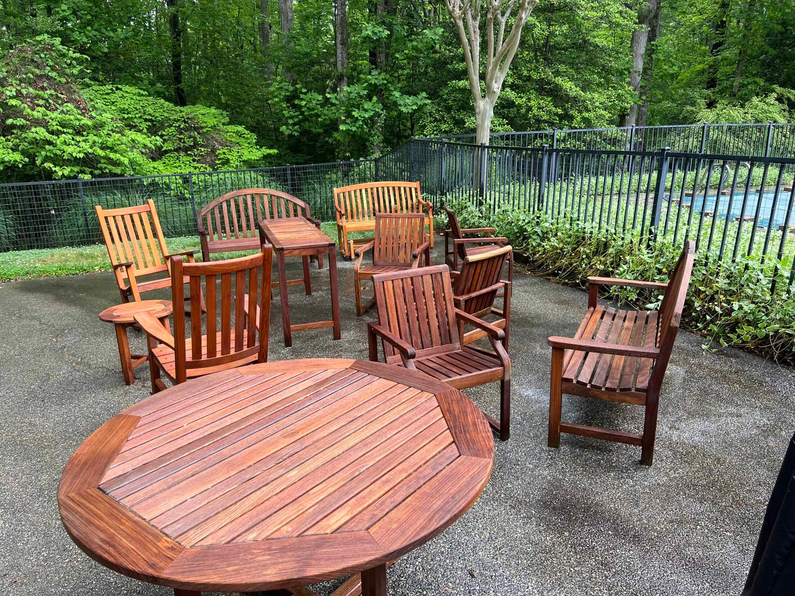Wooden patio furniture revived by soft washing and staining preformed by alpha exterior solutions
