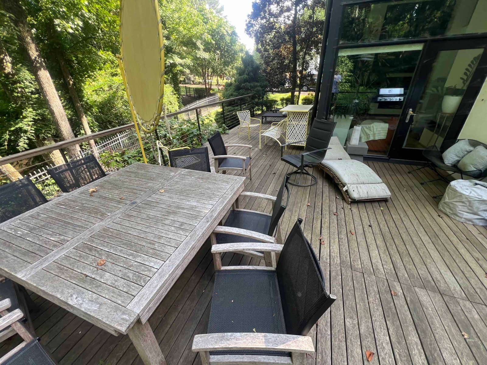 wooden deck and wooden patio furniture before being brought back to life by soft washing and deck staining by alpha exterior solutions in hanover virginia