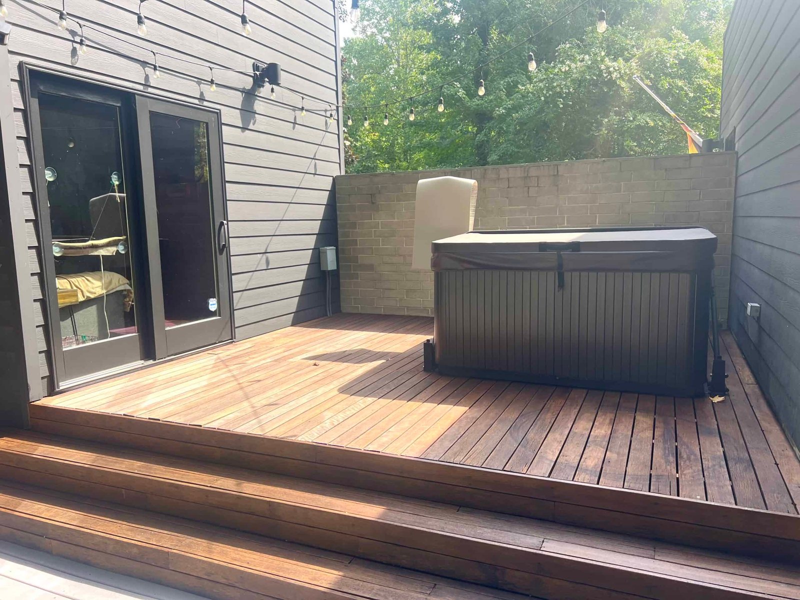 residential wooden deck patio after soft washing and staining by alpha exterior services