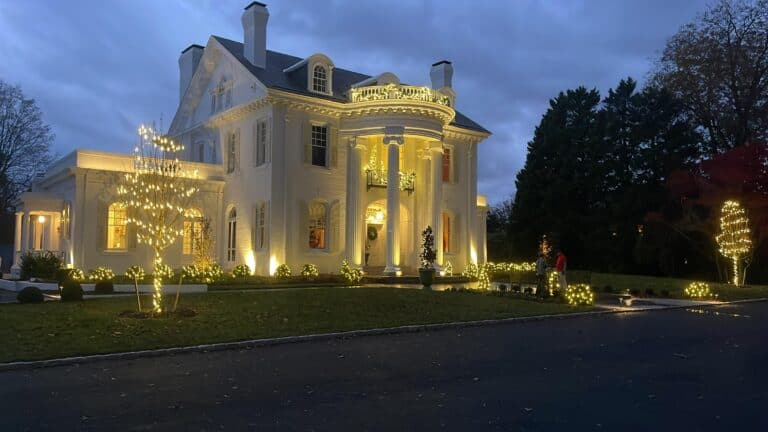 Large residential home decorated for christmas by alpha exterior solutions in white stone, VA