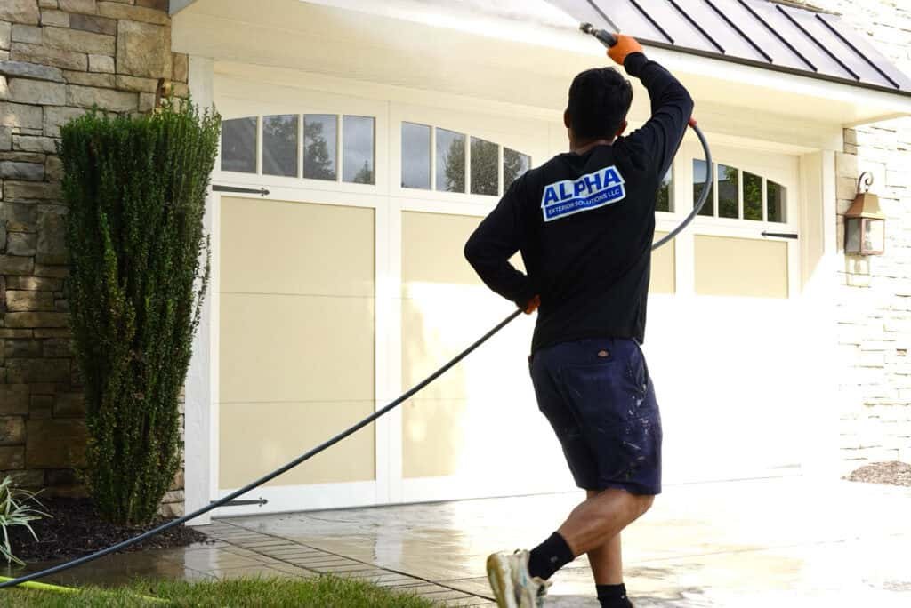 Alpha exterior services crew member professionally cleaning home in Ashland VA