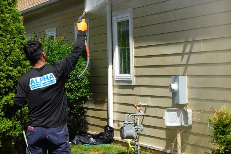 Alpha exterior services crew member professionally cleaning home in Hanover VA