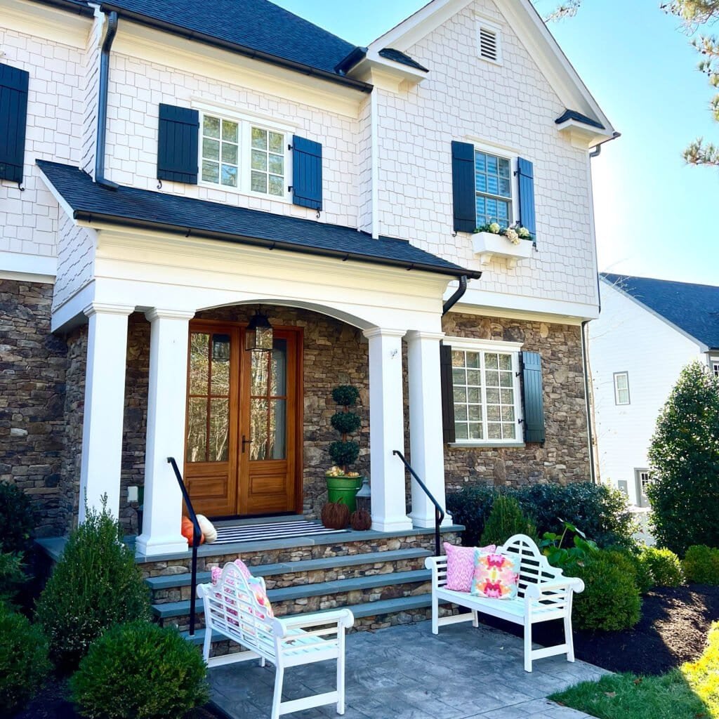Large stone and siding home with covered front porch at a residence in White Stone Virginia