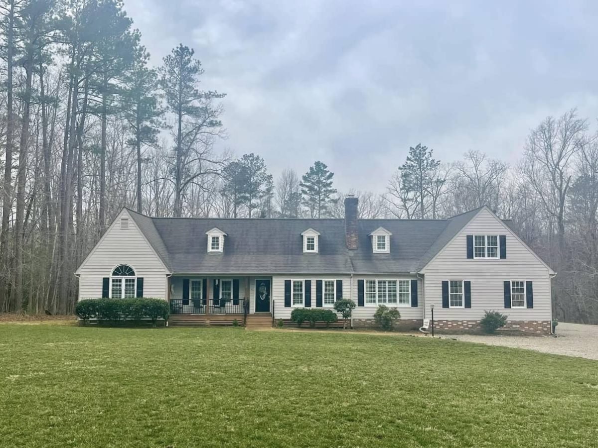 Residential home with stained asphalt roof before professional soft washing by alpha exterior solutions in hanover va