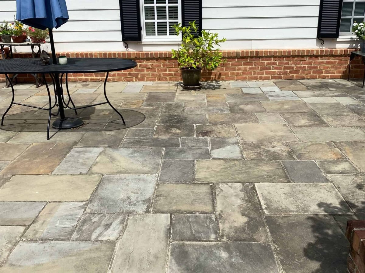 dirty, stained residential paver patio before being sealed and power washed by alpha exterior services in hanover virginia