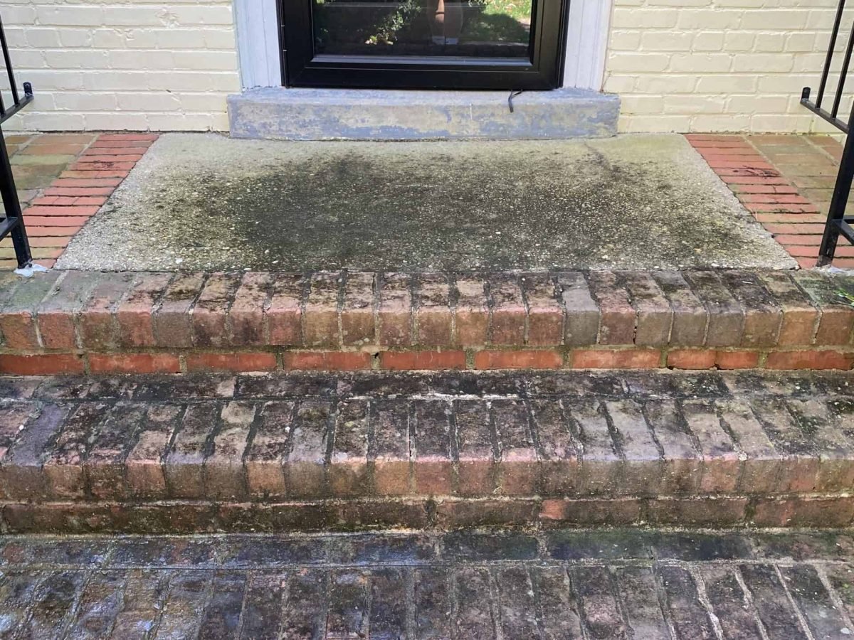 residential brick and pebble entry staircase before soft wash and sealing by alpha exterior services cleaning