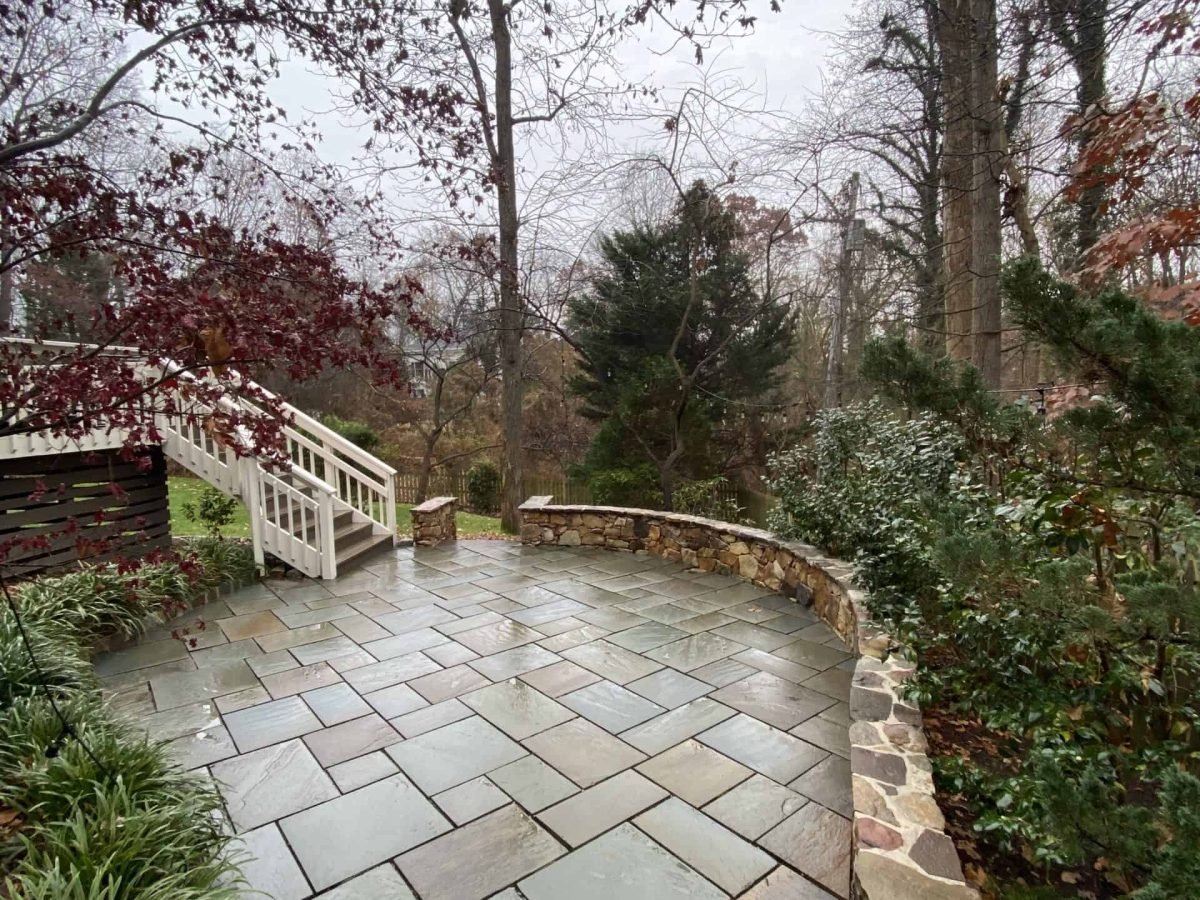 after photo of outdoor patio and rock retaining wall after power washing and paver sealing preformed by alpha exterior solutions